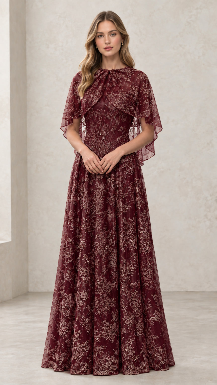 Woman wearing Burgundy embroidered lace capelet evening gown