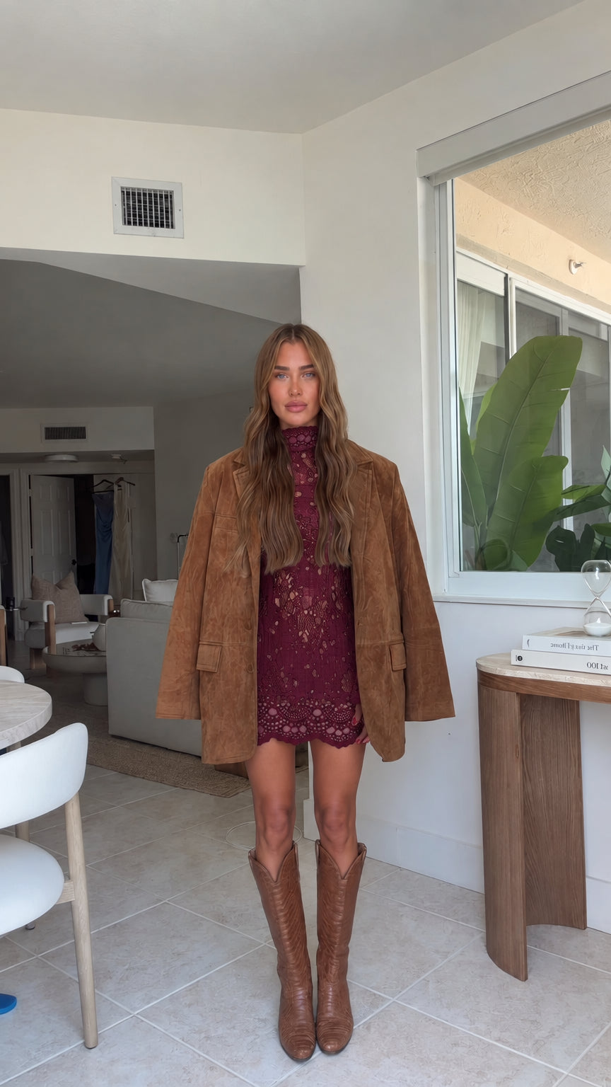 Full front view of model wearing camel faux suede blazer with wine burgundy lace dress