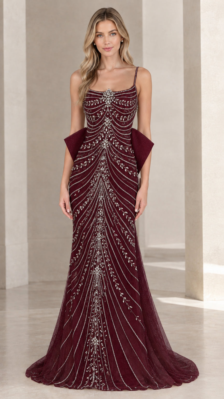 Front view of burgundy beaded spaghetti strap formal gown with back bow accent