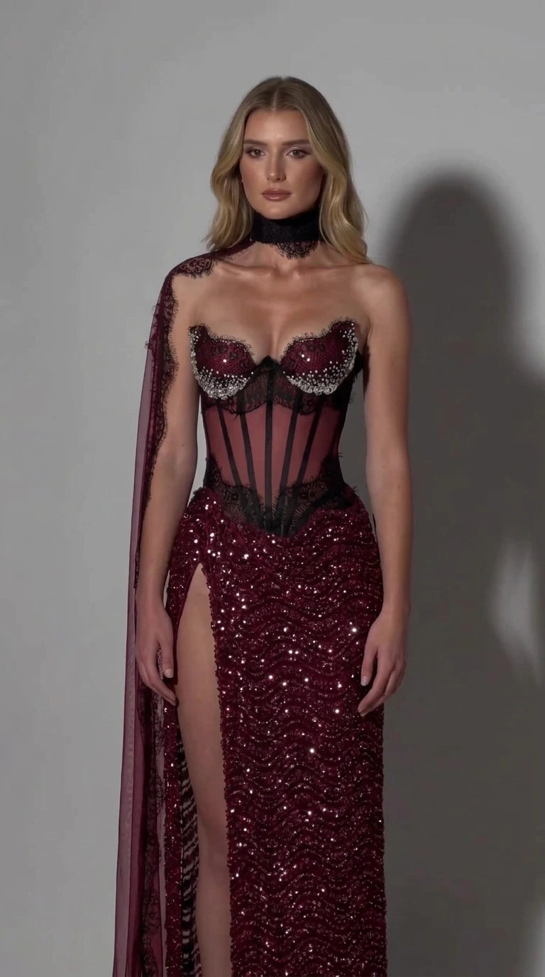 Full front view of burgundy sequined corset gown with black sheer boned bodice