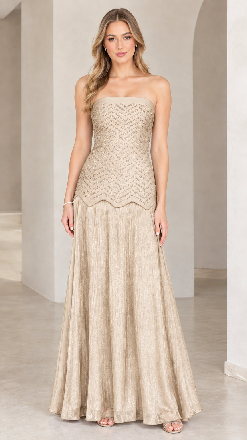 Full-length view of model in champagne gold strapless beaded evening gown