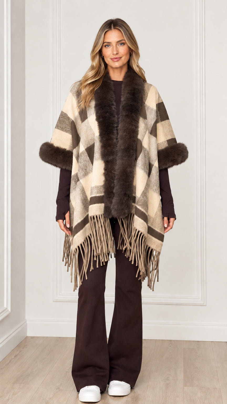 Woman wearing cream beige plaid poncho cape with faux fur accents