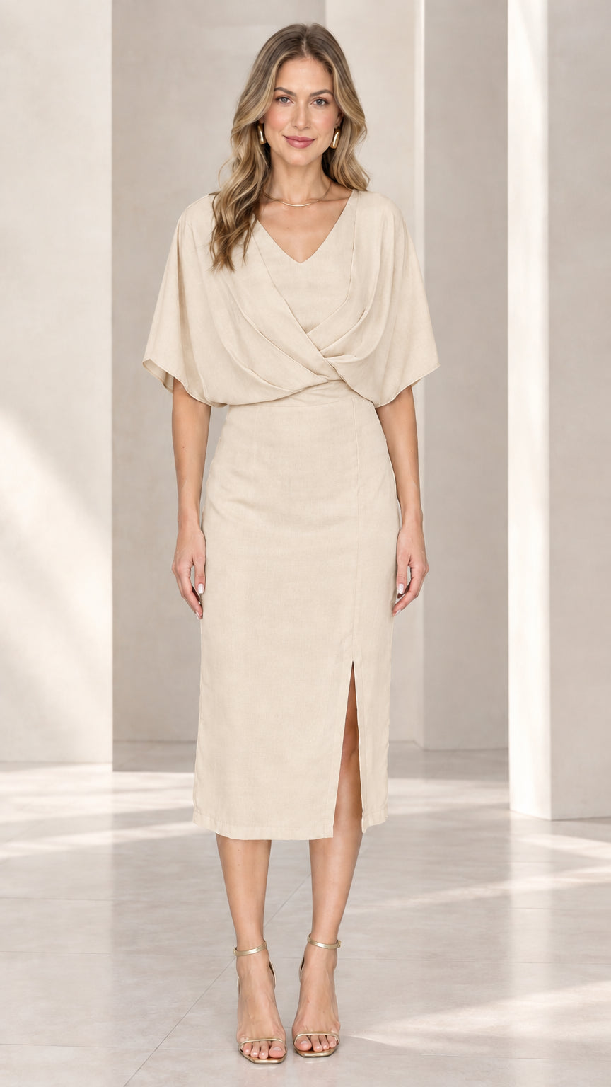 Front view of model wearing beige draped v-neck midi sheath dress