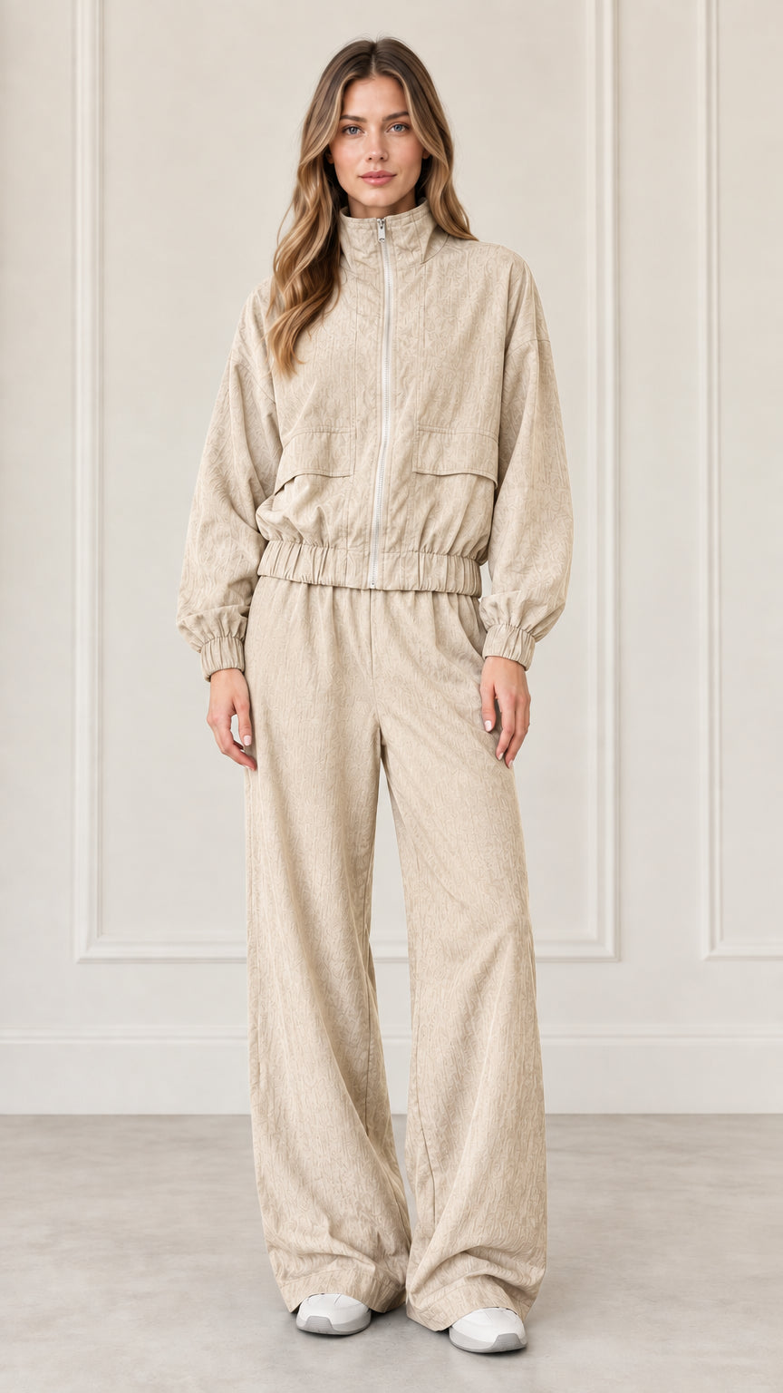 Front full-length view of woman wearing Beige zip-up jacket and wide-leg pants set