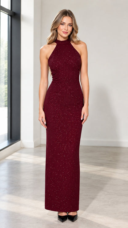 Front view of woman wearing burgundy shimmer halter neck maxi evening gown