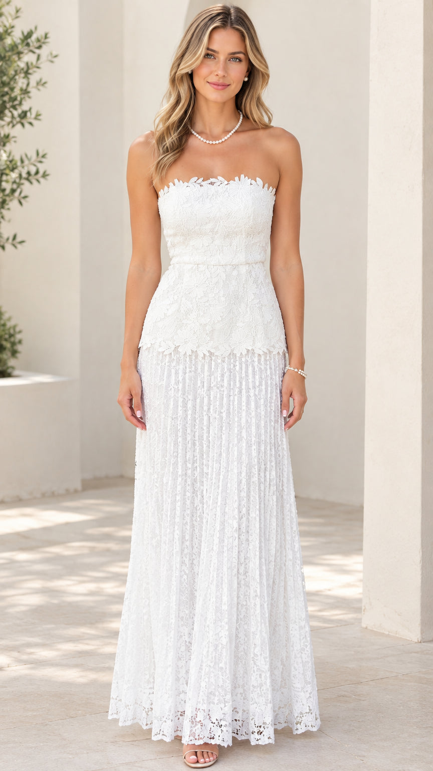 Front view of woman wearing white strapless floral lace maxi dress with scalloped neckline