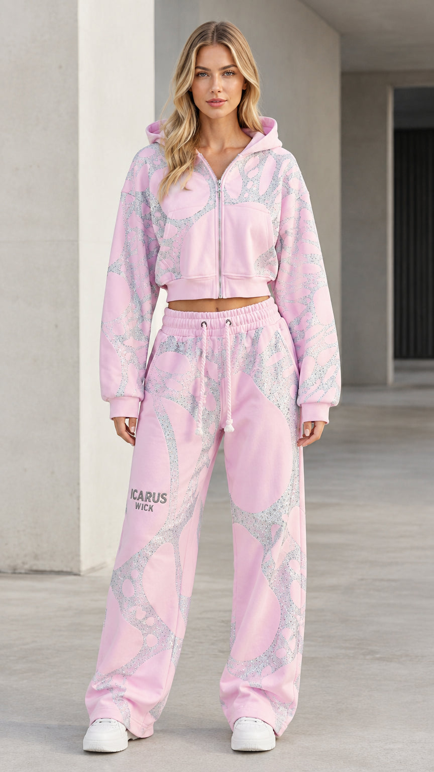 Front view of model wearing pink shimmering graphic cropped hoodie and wide-leg sweatpants set