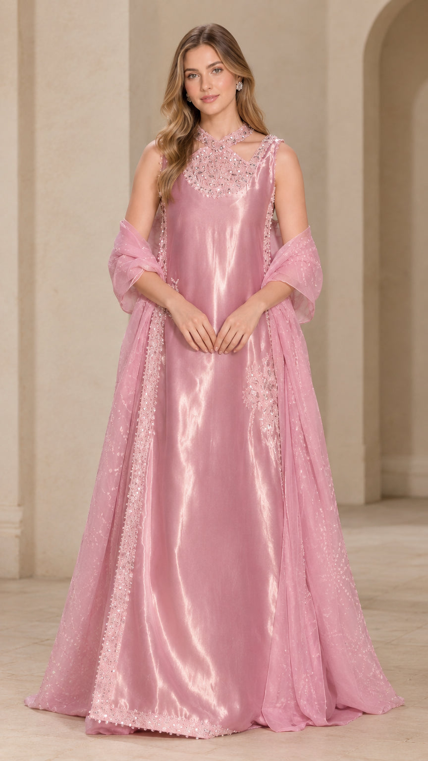 Front full-length view of woman wearing blush pink satin evening gown with beaded neckline and matching shawl