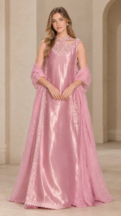 Front full-length view of woman wearing blush pink satin evening gown with beaded neckline and matching shawl