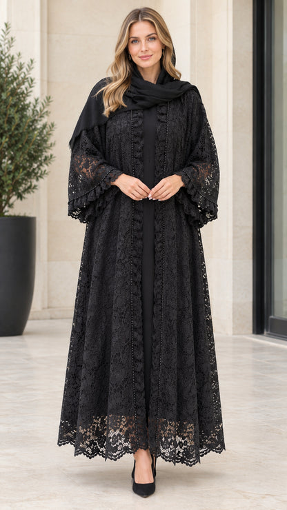 Front full-length view of woman wearing black floral lace maxi abaya with ruffle sleeves