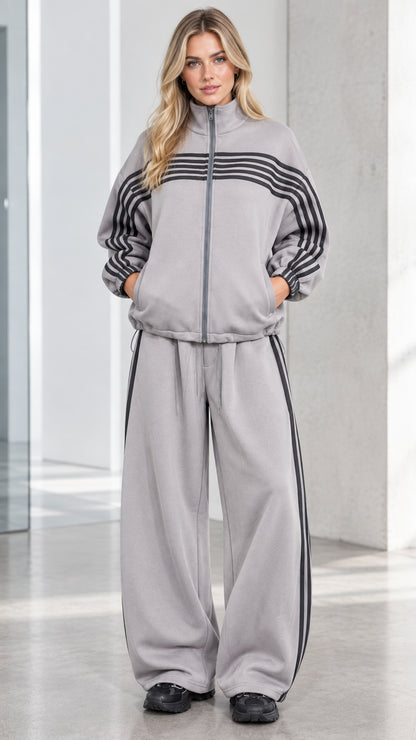 Front full view of woman wearing Heather Grey striped zip-up track jacket and wide-leg sweatpants set