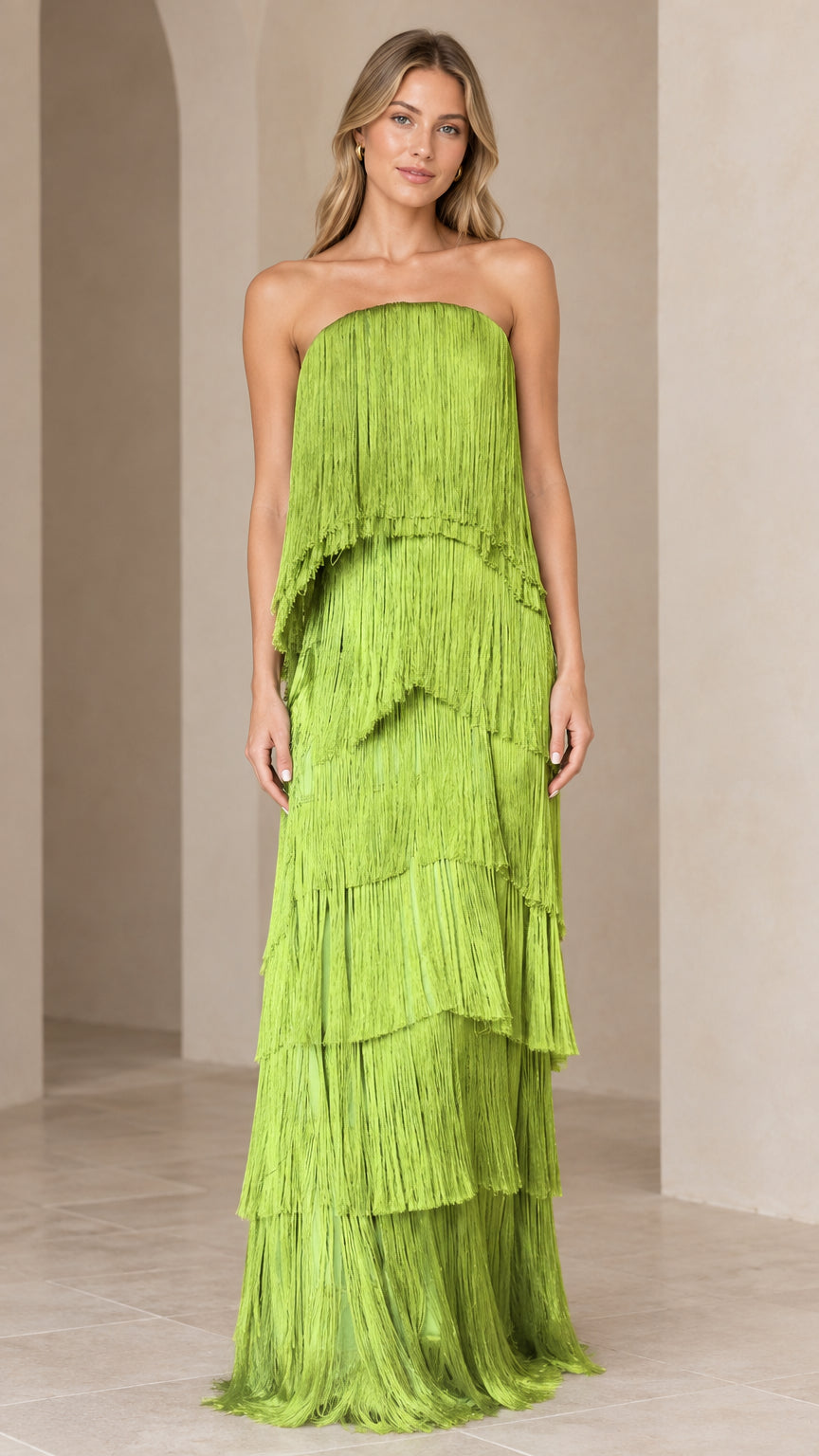 Front full-length view of model wearing a lime green strapless tiered fringe maxi dress