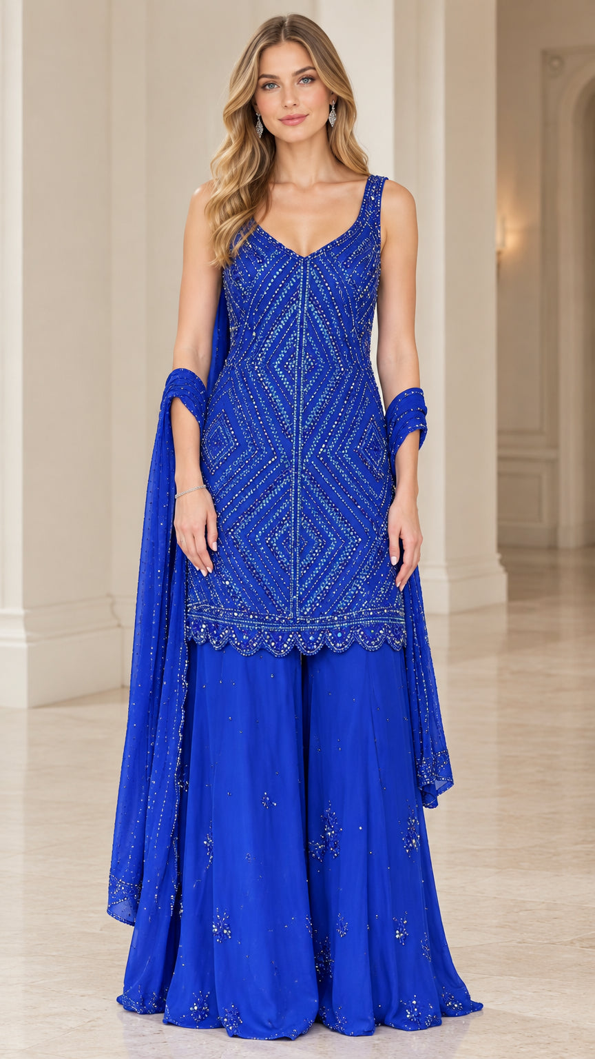 Front view of model wearing Royal Blue embellished sleeveless kurti with matching sharara pants and dupatta