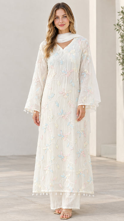 Full front view of model wearing white embroidered 3-piece kurta set with trousers and scarf