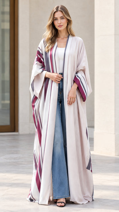 Full front view of woman wearing off-white striped open front maxi kimono duster with wide-leg jeans