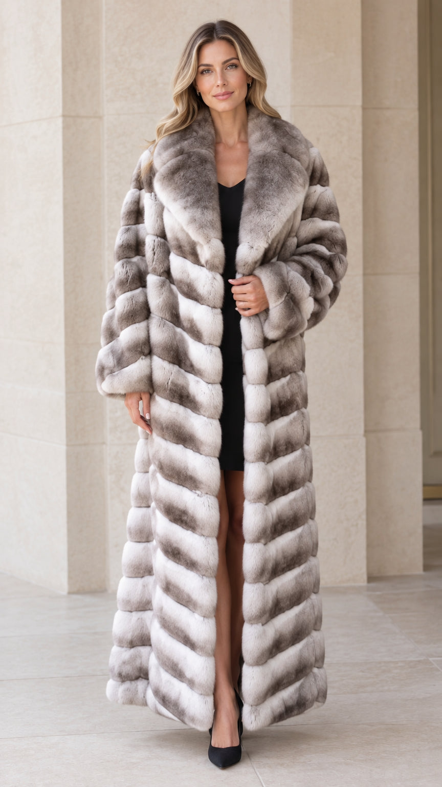 Front view of woman wearing full-length grey ombre chevron faux fur maxi coat