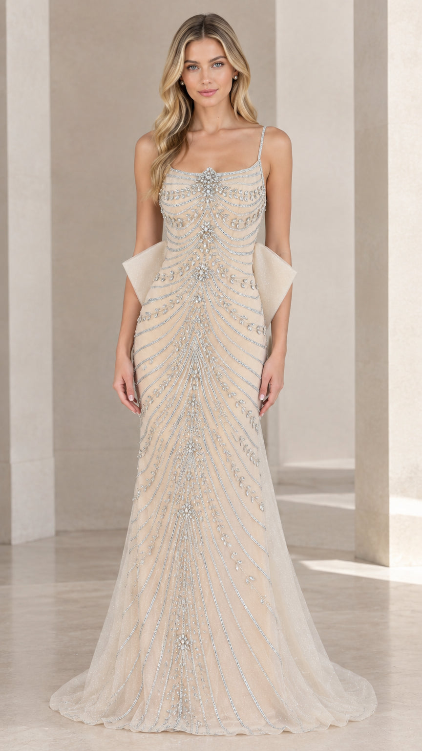 Front view of champagne beaded spaghetti strap evening gown with back bow accents