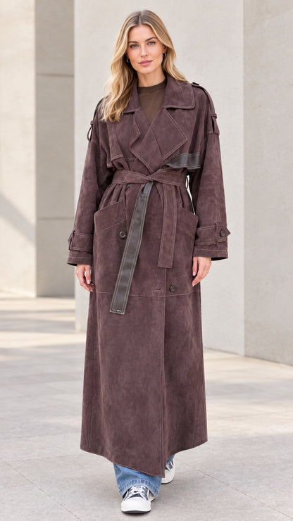 Front view of model wearing brown maxi suede-look trench coat with belt