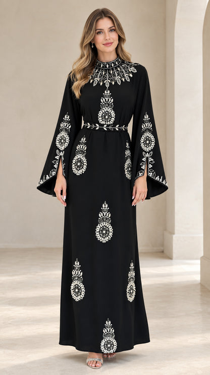 Front full view of woman wearing black rhinestone embellished split bell sleeve maxi dress