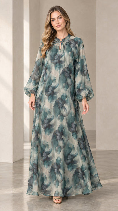 Front view of woman wearing a sage green watercolor floral chiffon maxi dress with long balloon sleeves