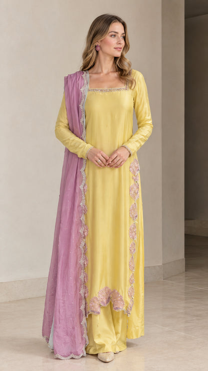 Front view of model wearing Yellow embroidered square neck kurta set with lavender dupatta