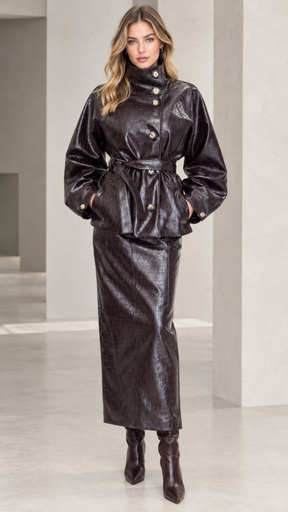 Front view of woman wearing Dark Brown croc-embossed faux leather belted jacket and maxi skirt set