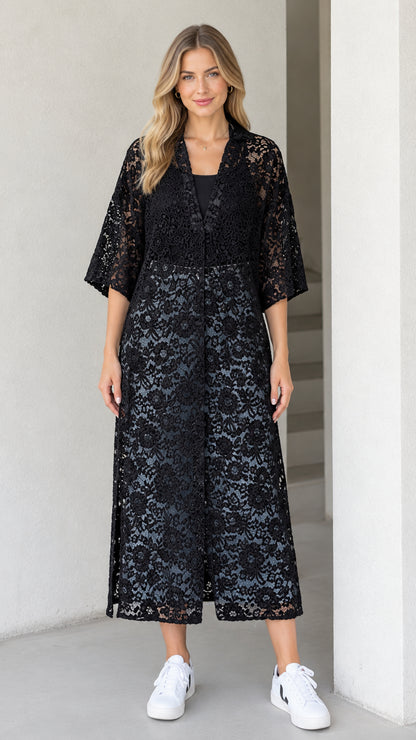 Front view of model wearing black floral lace midi duster dress with 3/4 sleeves