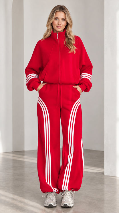 Front view of woman wearing red zip-up jacket and wide-leg striped track pants set
