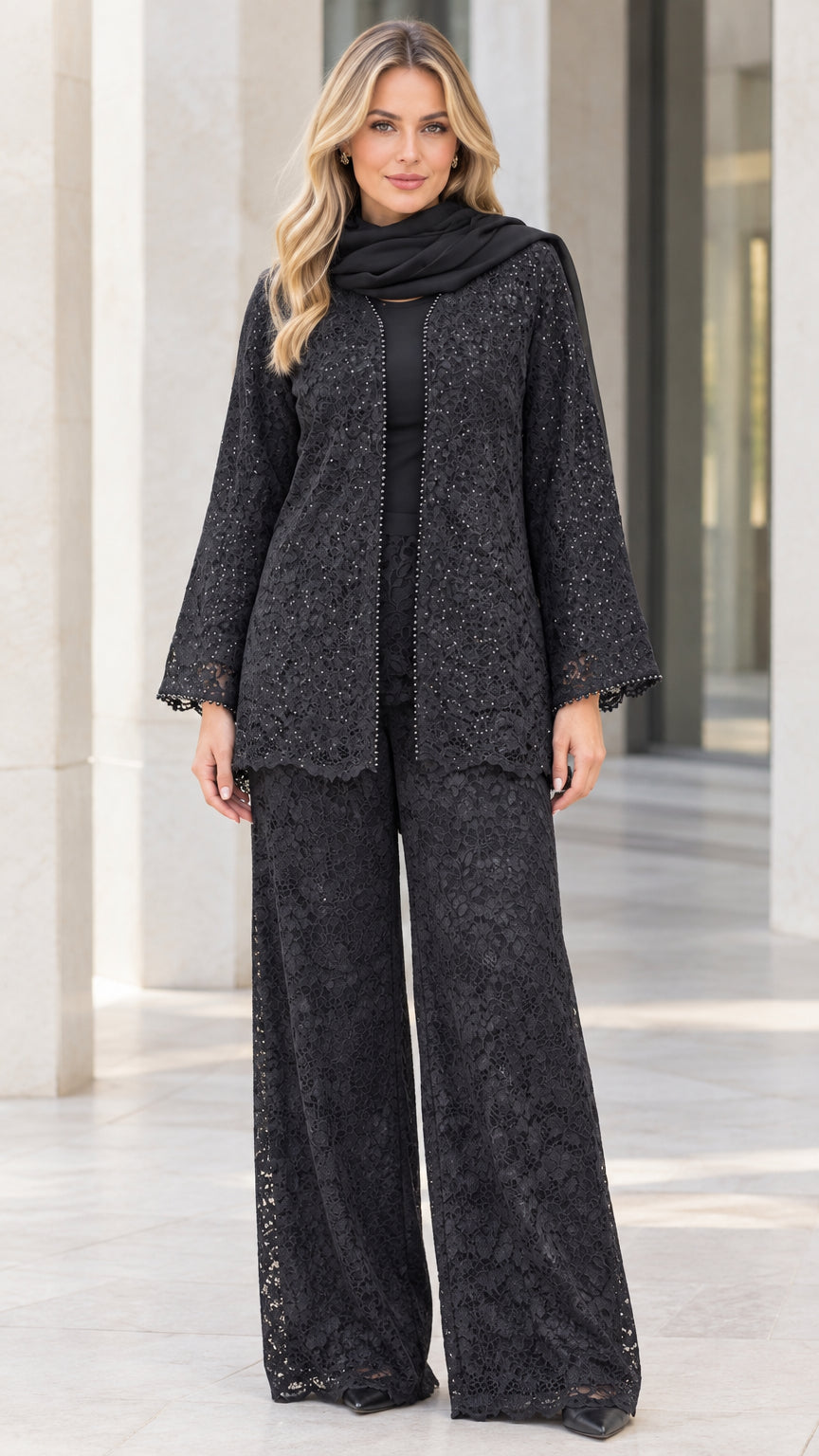 Front full-body view of model wearing black sequined floral lace pant suit set with matching scarf