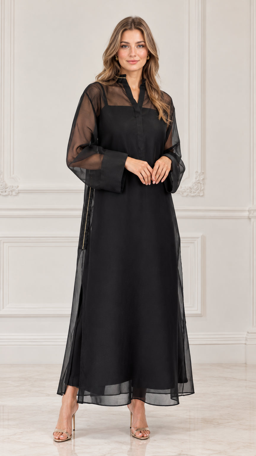 Front view of model wearing black sheer overlay maxi dress with long sleeves