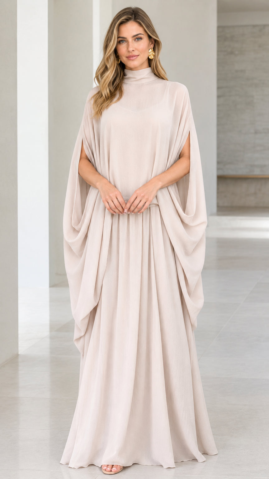 Front view of model wearing champagne high neck cape sleeve maxi dress
