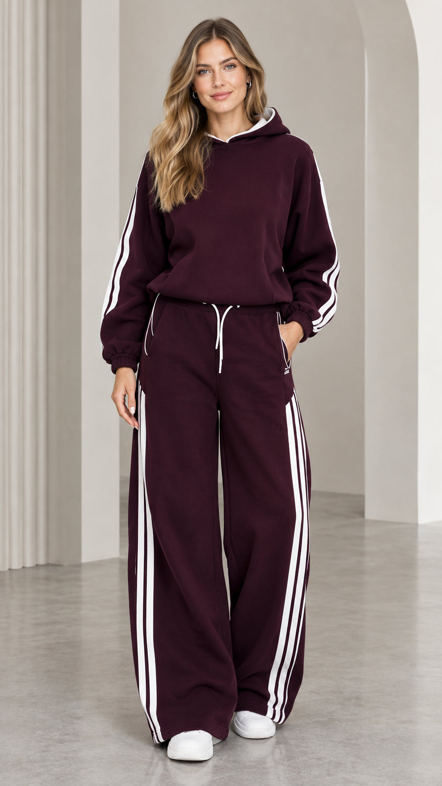 Front view of woman wearing burgundy two-piece hoodie and wide leg sweatpants tracksuit set