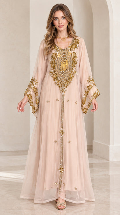 Front view of woman wearing blush pink gold embroidered kaftan maxi dress