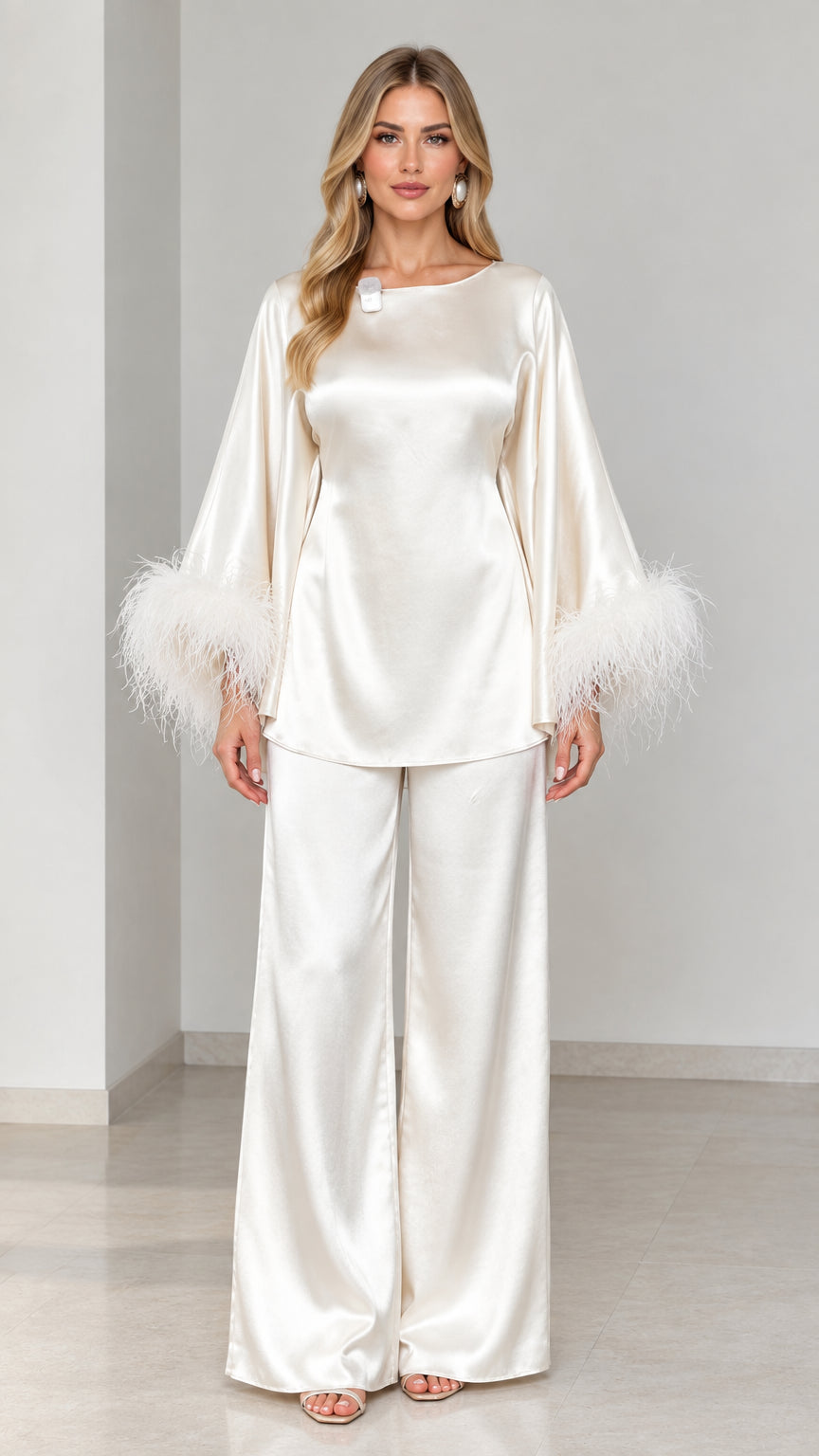 Model wearing ivory satin two-piece set with feather trim cuffs front view