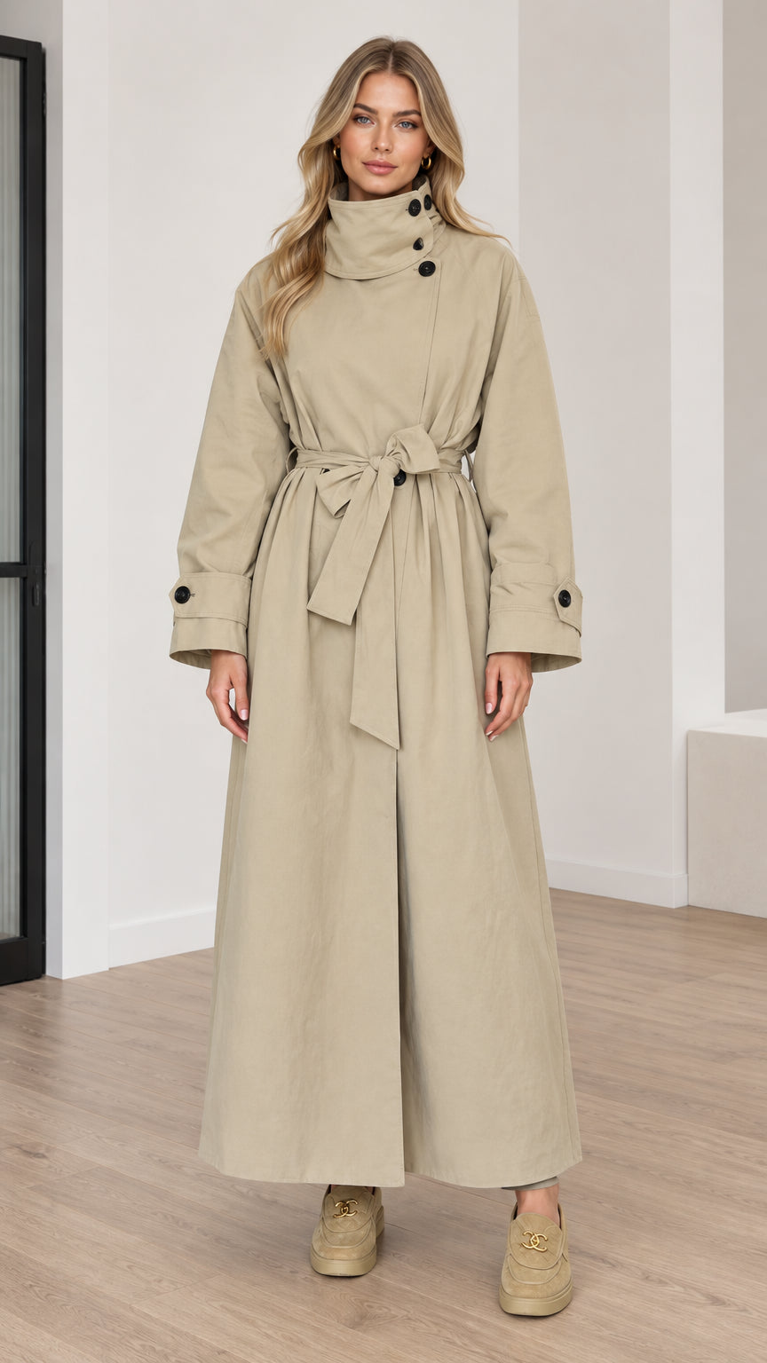 Full front view of women's beige maxi trench coat with high collar and tie belt