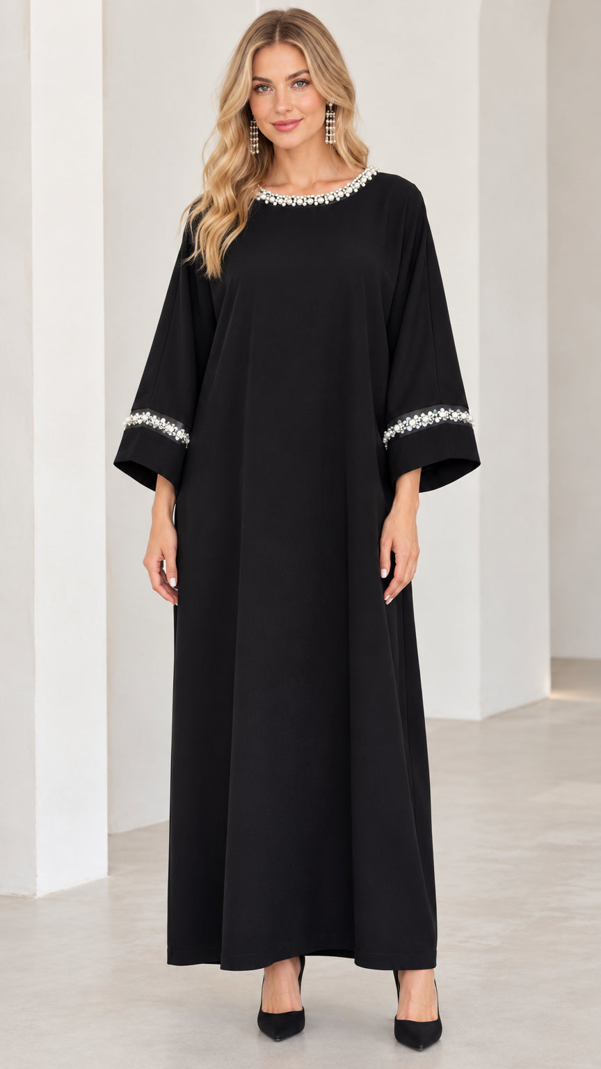 Front view of woman wearing black pearl-embellished modest maxi dress
