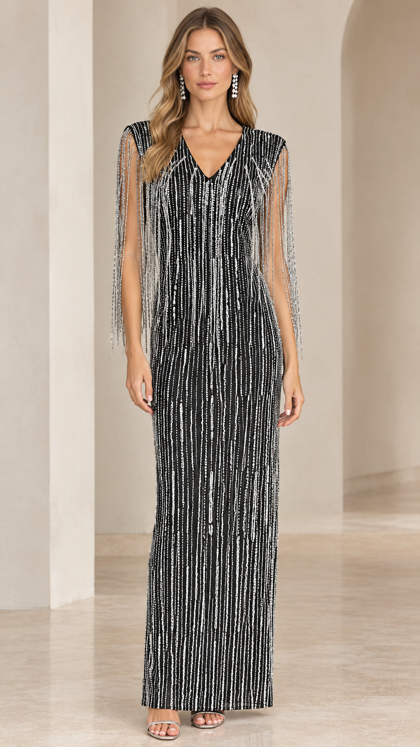 Front view of black sequin column maxi gown with beaded shoulder fringe