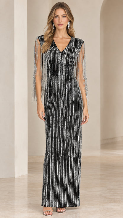 Front view of black sequin column maxi gown with beaded shoulder fringe