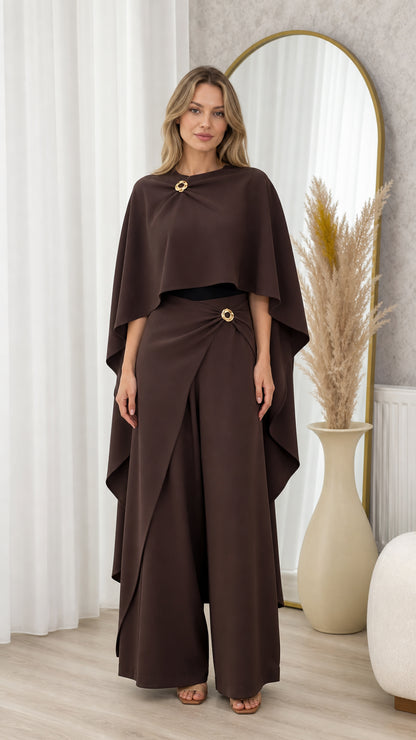 Full front view of model wearing chocolate brown draped cape top and matching wide-leg trousers set