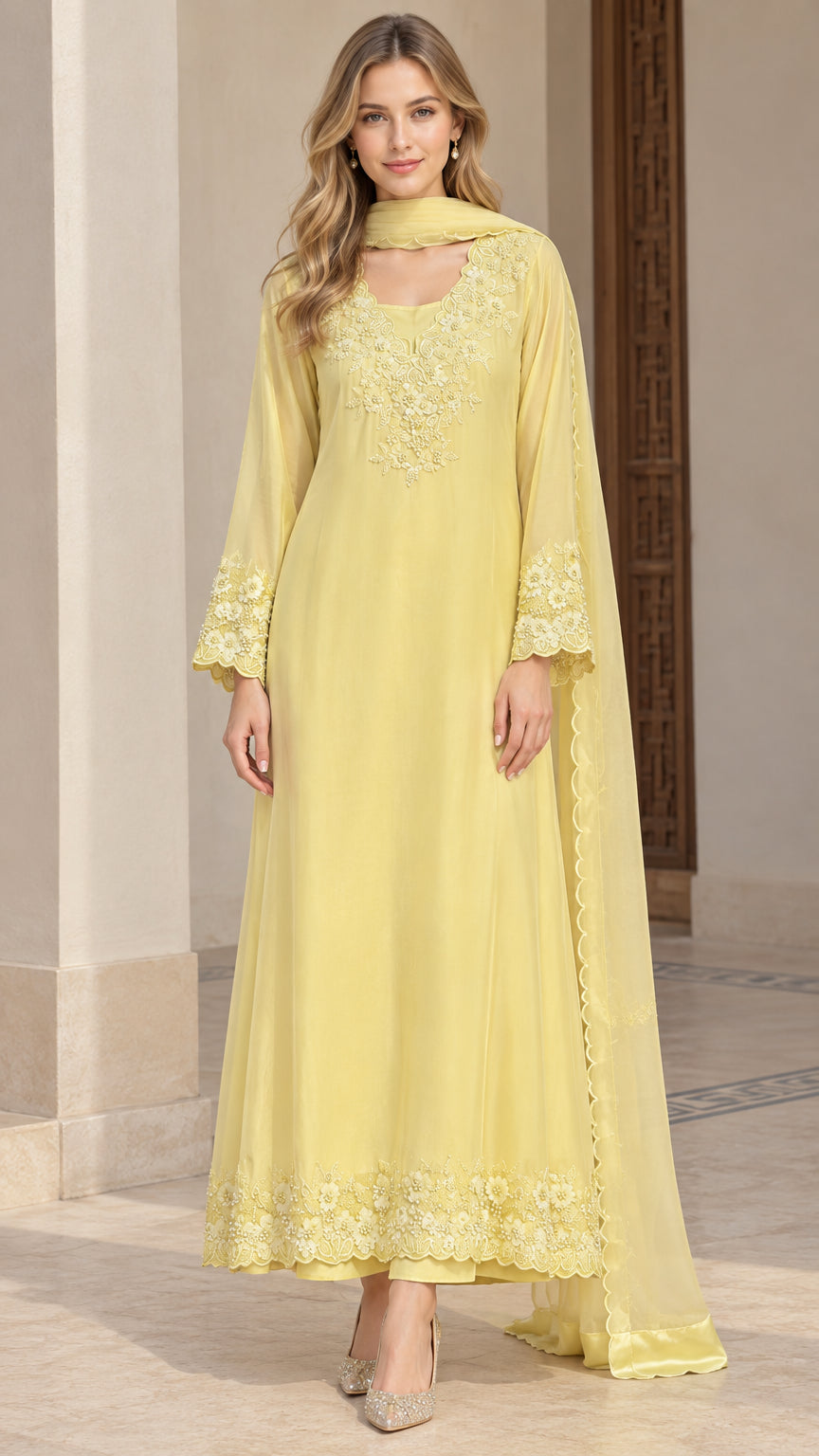 Front view of woman wearing yellow embroidered long tunic dress with matching pants and scarf