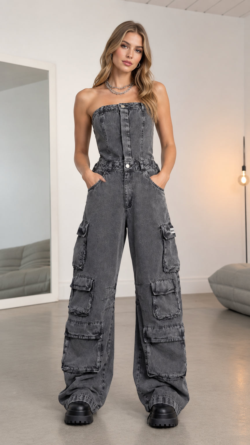 Front full-length view of model wearing washed charcoal strapless wide leg denim cargo jumpsuit