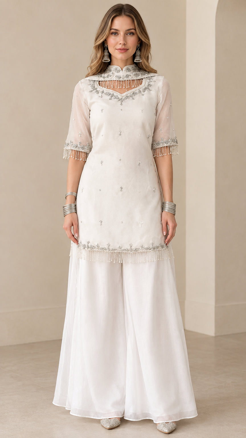 Front full view of white embroidered kurti sharara suit set with beaded fringe