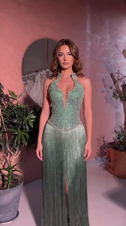 Front view of model wearing Sage Green halter rhinestone fringe evening maxi dress