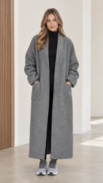 Full front view of women's grey bouclé maxi duster coat styled over black top