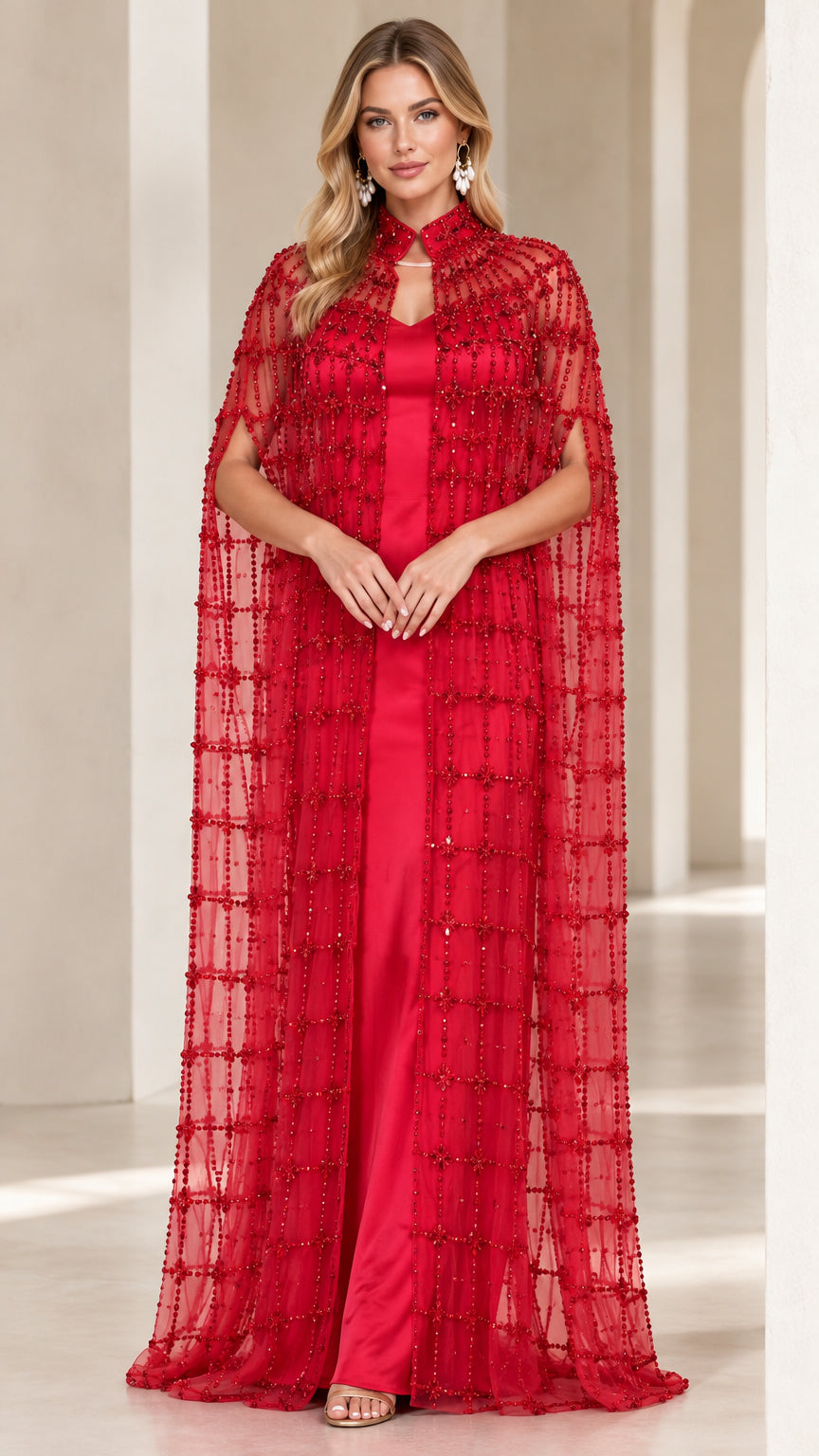 Front view of red formal evening gown with beaded sheer cape overlay