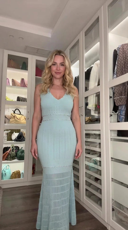 Front full view of woman wearing light blue sleeveless knit mermaid maxi dress