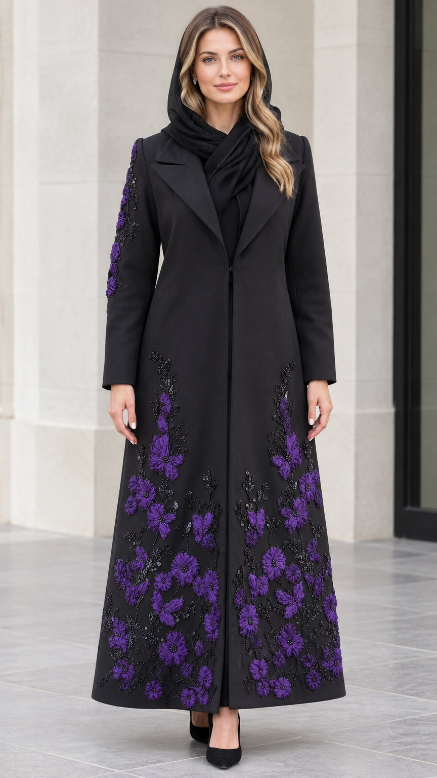 Front view of black longline maxi coat with purple floral applique and notched lapels