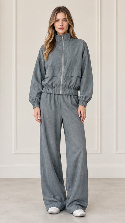 Front full-length view of woman wearing Dusty Blue zip-up jacket and wide-leg matching pants set