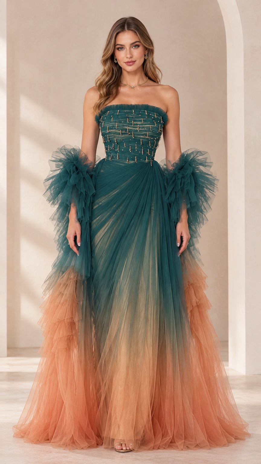 Front view of model wearing teal and peach ombre strapless beaded tulle evening gown with ruffled sleeve wraps