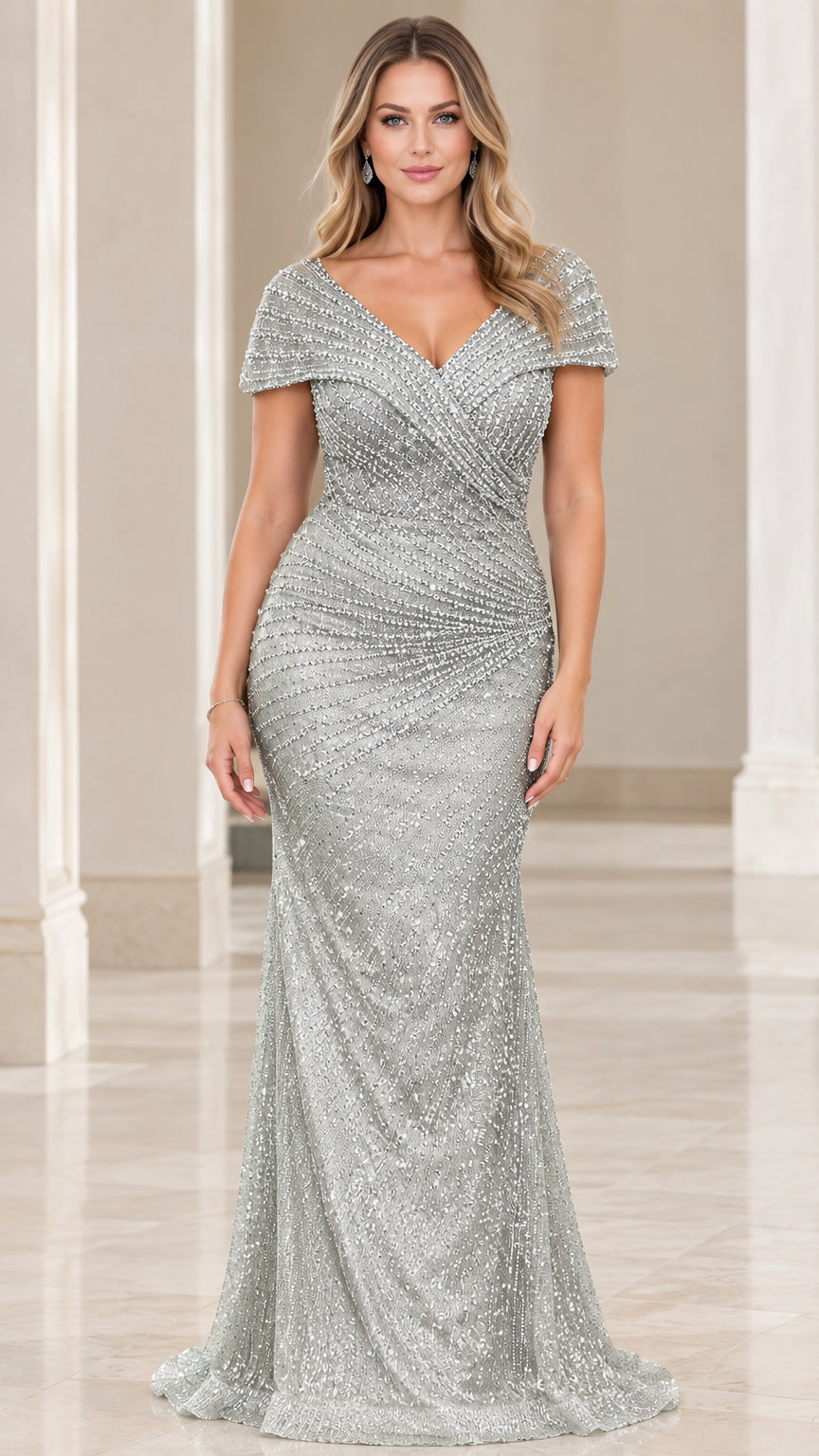 Front view of model wearing a shimmering silver beaded mermaid evening gown with cap sleeves